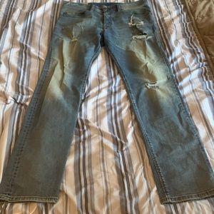 Light blue diesel jeans with distressed cuts